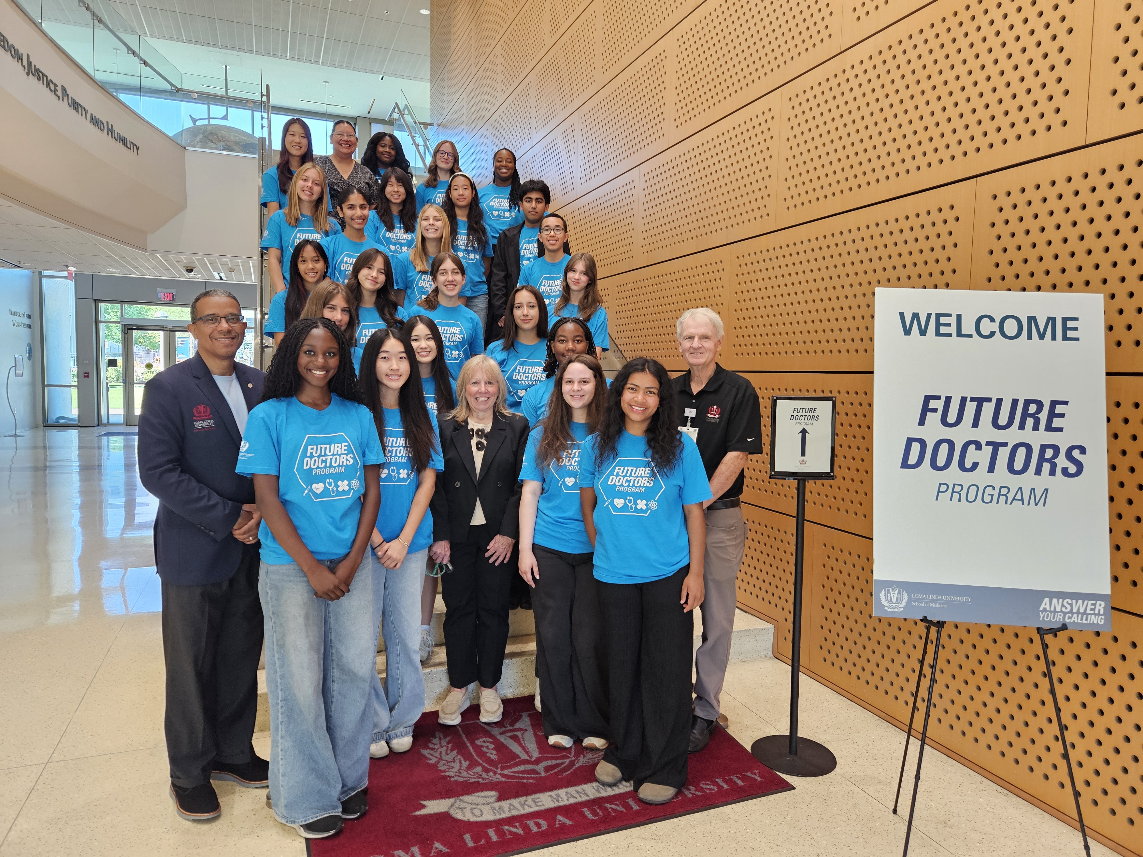 Group of students and physicians standing on stairs 