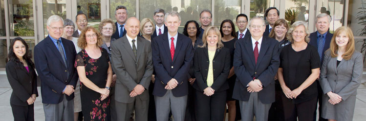 Group photo of all the deans standing in front of Coleman Pavilion