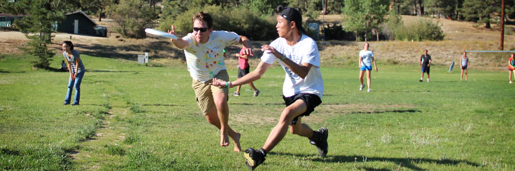 students play frisbee outside