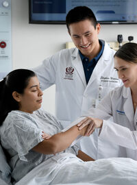 medical student bedside with patient and physician