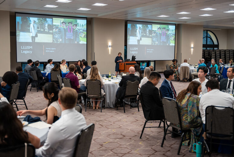 Photo of keynote speaker with group around round table