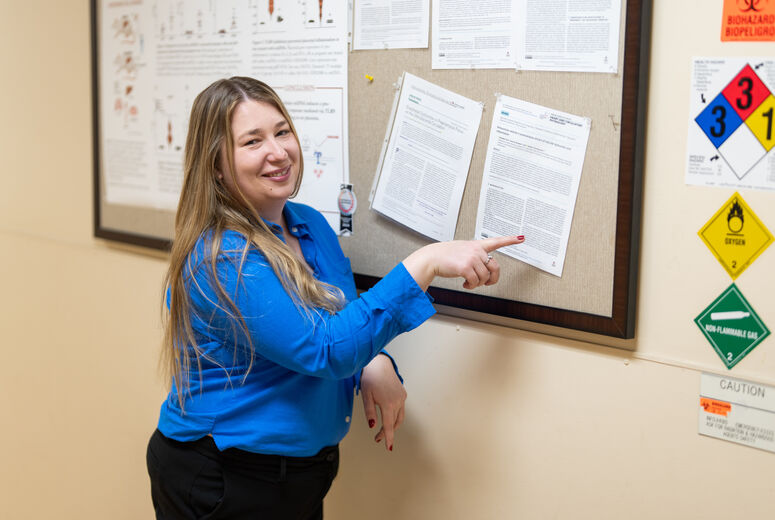 female researcher pointing to a published paper