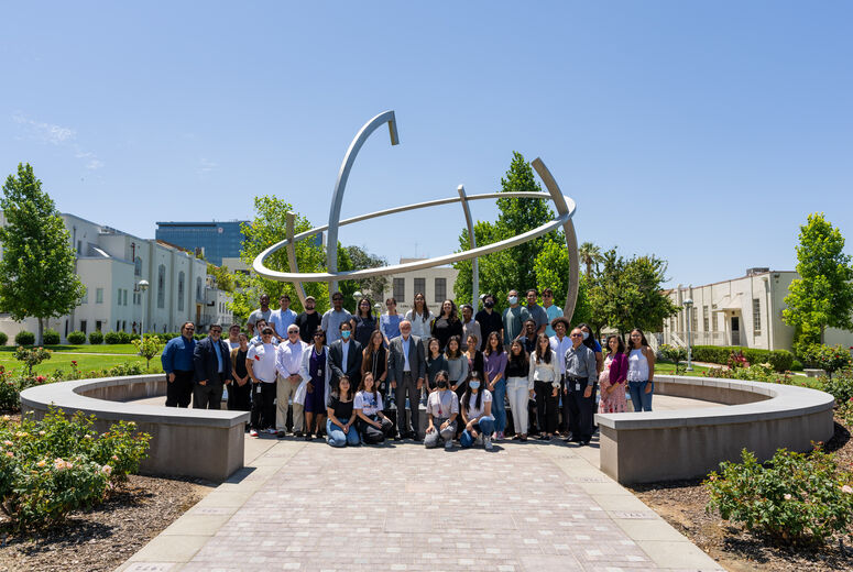 Students take a group photo with Dr. Richard Hart, president of LLUH