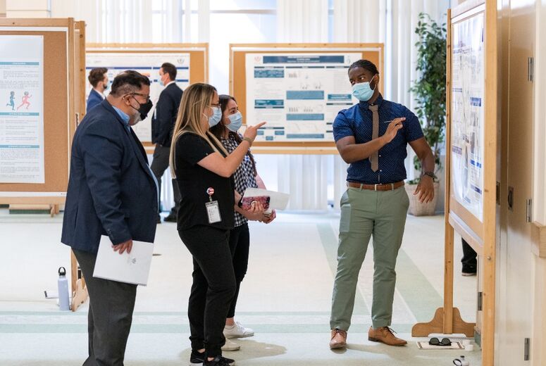 Research students present scientific poster presentations on their investigations