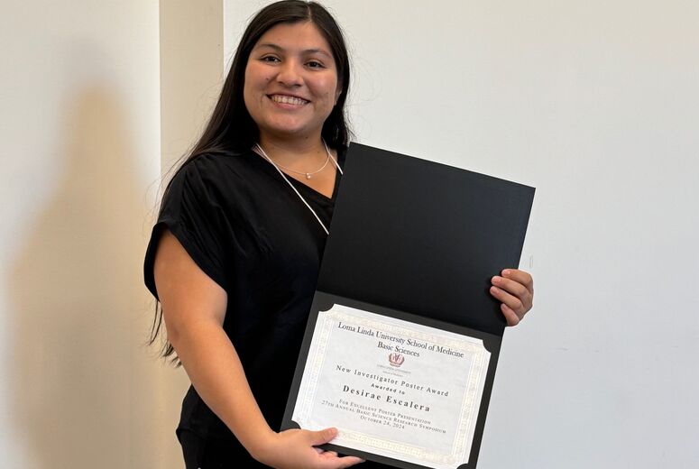Desirae Escalera receives the New Investigator Poster Award at the 2024 LLU School of Medicine Basic Sciences Research Symposium