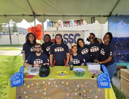 students behind a table at festival event