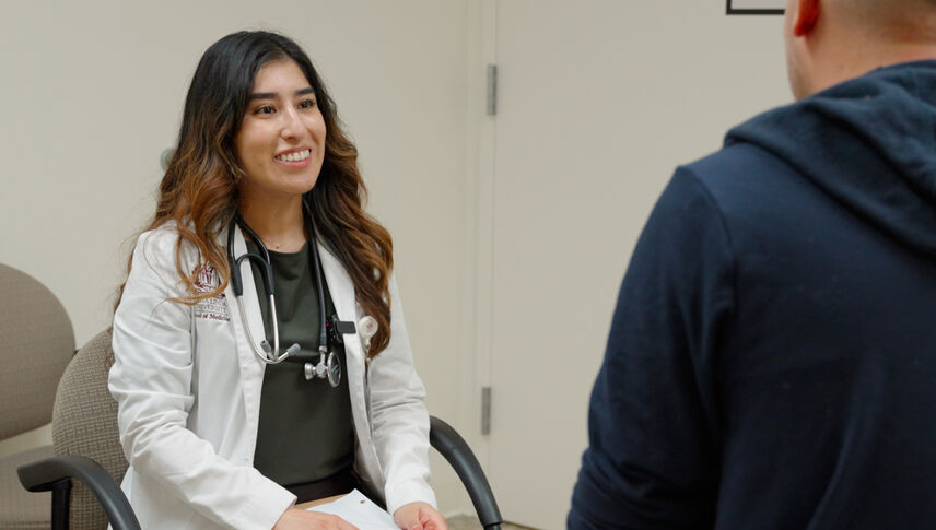 woman sitting with man in blue sweater